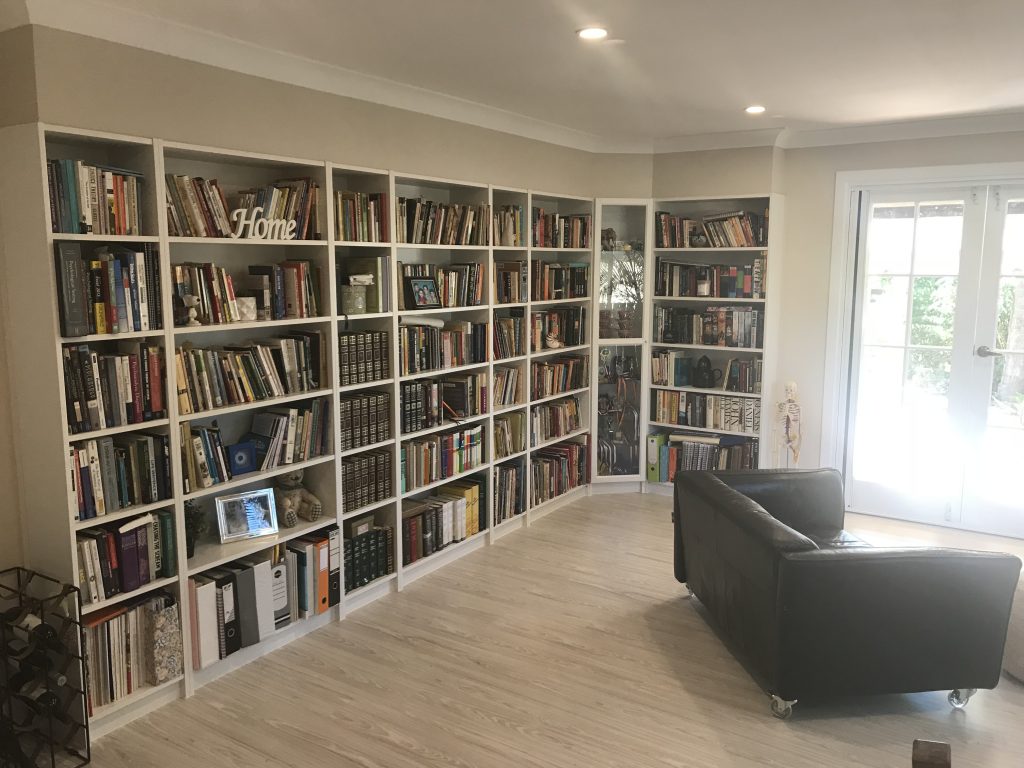 Floor-to-ceiling built-in library shelving built by Pristine Homes in a Brisbane home